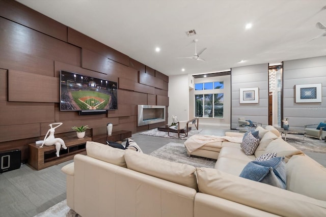 living area with a fireplace, recessed lighting, visible vents, and ceiling fan