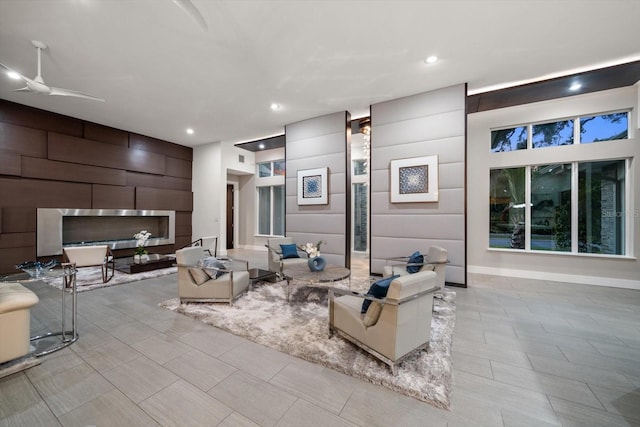 living room with recessed lighting, a ceiling fan, and baseboards