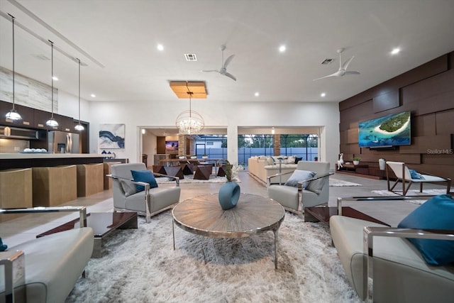 living area featuring recessed lighting, visible vents, and ceiling fan with notable chandelier