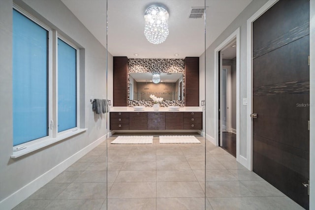 full bath with vanity, baseboards, visible vents, tile patterned flooring, and a chandelier