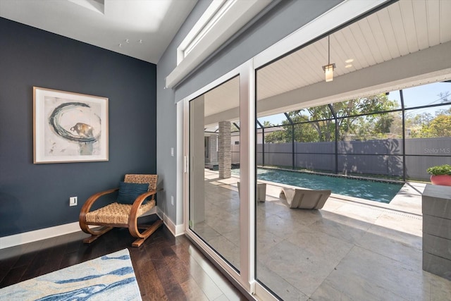 living area featuring baseboards and wood finished floors