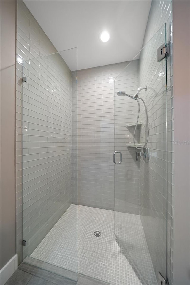 bathroom with a shower stall and recessed lighting