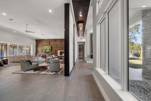 corridor with recessed lighting, visible vents, baseboards, and wood finish floors