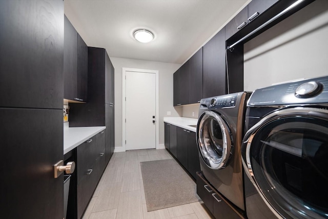 laundry room featuring cabinet space and washer and clothes dryer