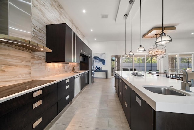 kitchen with range hood, visible vents, a sink, modern cabinets, and backsplash