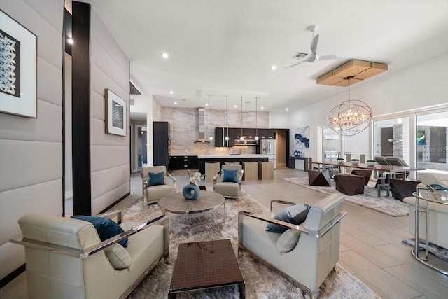 living room featuring an inviting chandelier and recessed lighting