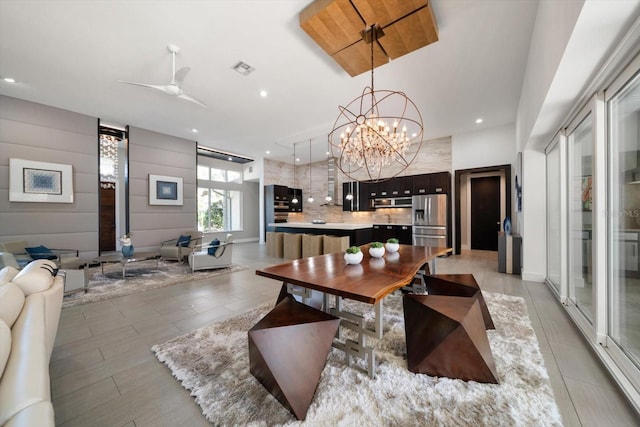 living area featuring visible vents, recessed lighting, and ceiling fan with notable chandelier