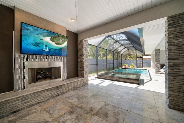 view of patio / terrace with glass enclosure, an outdoor fireplace, a fenced in pool, and fence