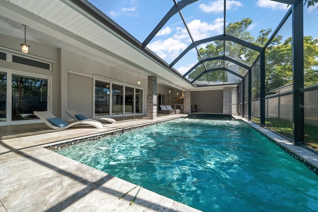 view of pool featuring a patio area, glass enclosure, and a fenced in pool