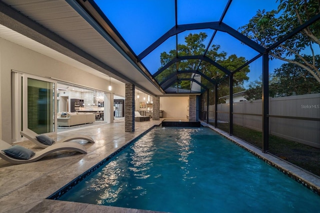 view of swimming pool featuring a patio area, a fenced in pool, glass enclosure, and fence