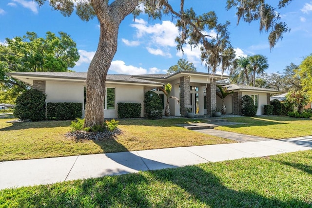 view of front of home with a front lawn and stucco siding