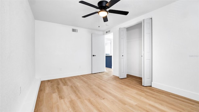 unfurnished bedroom with light wood finished floors, baseboards, visible vents, and a ceiling fan