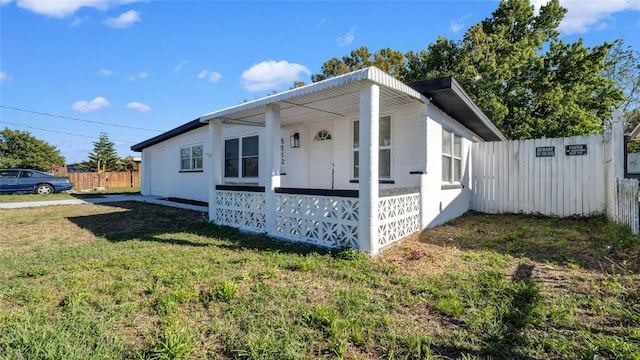 view of front facade featuring a front yard and fence