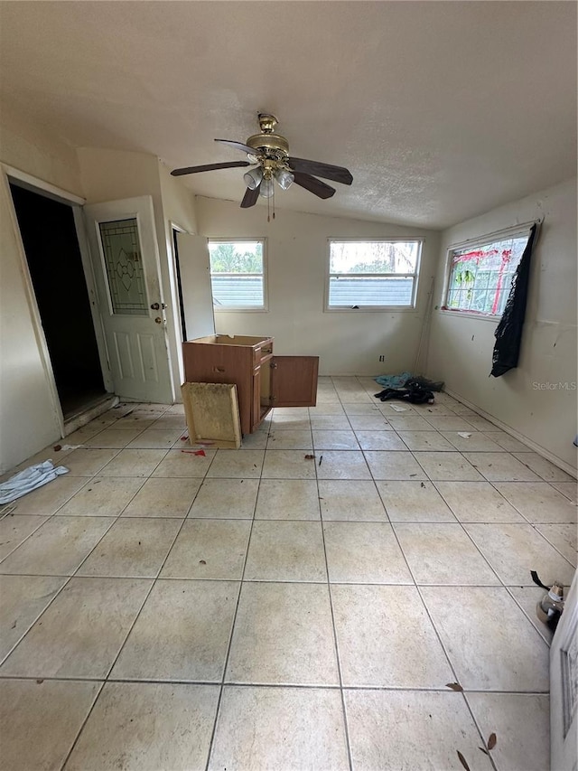 spare room featuring light tile patterned floors, ceiling fan, and plenty of natural light