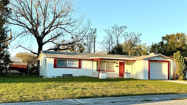 ranch-style home featuring a garage, a front lawn, and concrete driveway