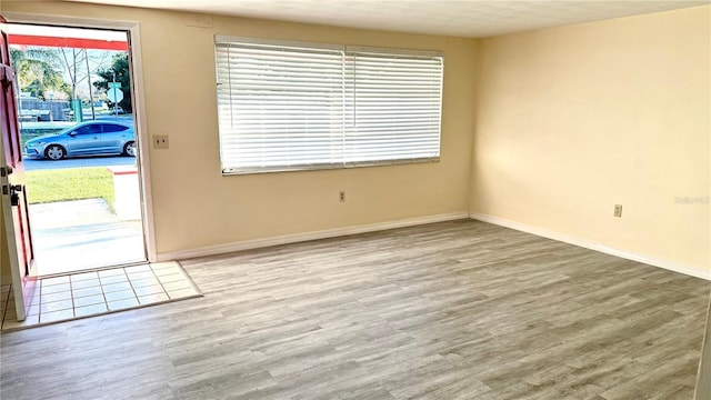 interior space with baseboards and wood finished floors