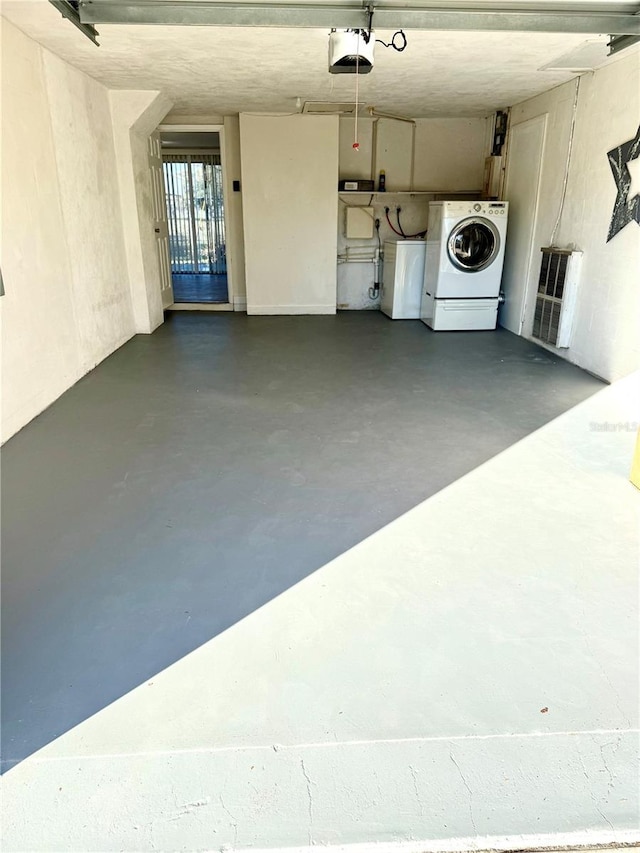 garage featuring washer and clothes dryer and a garage door opener