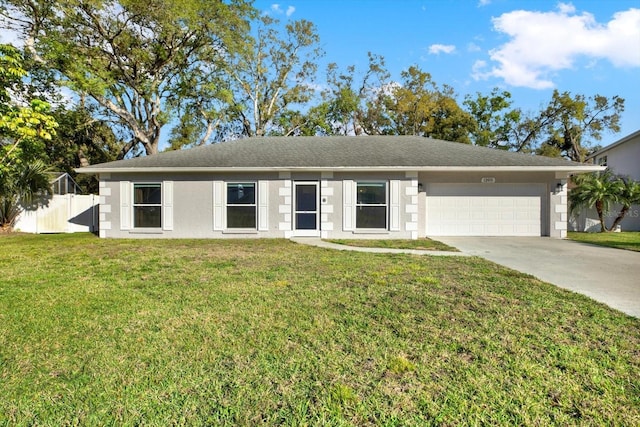 ranch-style house featuring an attached garage, fence, concrete driveway, stucco siding, and a front yard