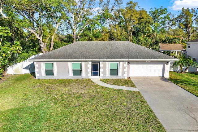 ranch-style home featuring roof with shingles, concrete driveway, fence, a garage, and a front lawn