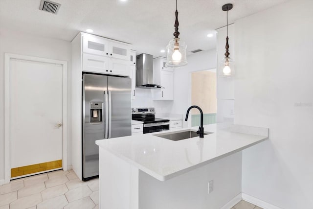 kitchen featuring stainless steel appliances, white cabinets, a sink, a peninsula, and wall chimney exhaust hood