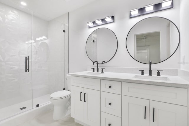 bathroom with a stall shower, a sink, and toilet