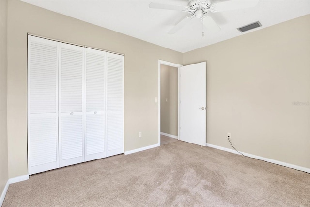 unfurnished bedroom featuring a ceiling fan, visible vents, baseboards, a closet, and carpet