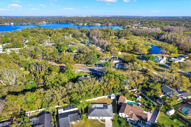 aerial view with a water view and a forest view