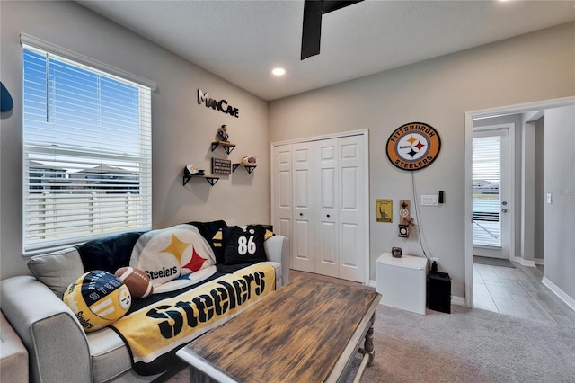 carpeted living room with recessed lighting, a textured ceiling, baseboards, and ceiling fan