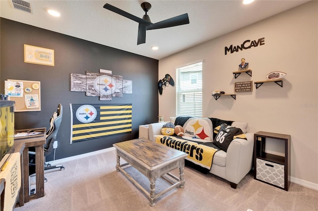 carpeted living area with recessed lighting, visible vents, baseboards, and a ceiling fan