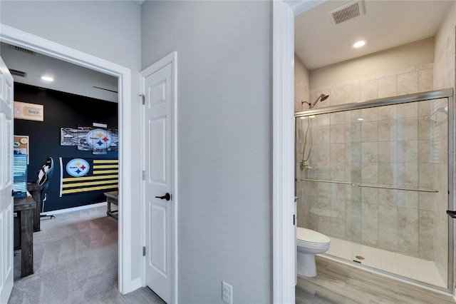 full bathroom with visible vents, baseboards, toilet, and a shower stall