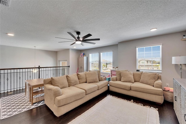 living area featuring recessed lighting, visible vents, and dark wood finished floors