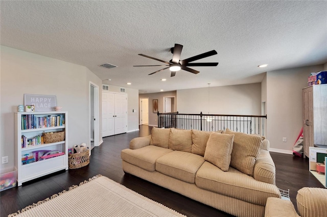 living room with recessed lighting, visible vents, dark wood-style flooring, and baseboards