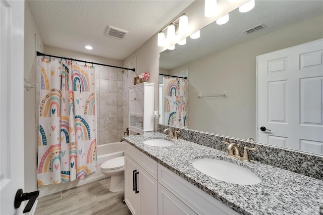 full bathroom featuring a sink, visible vents, shower / bath combo with shower curtain, and toilet