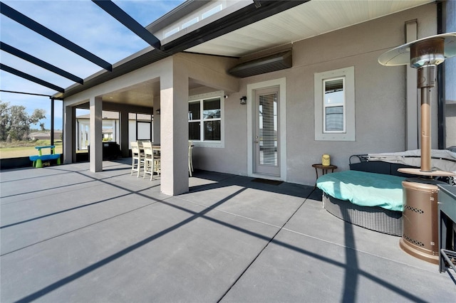 view of patio / terrace with glass enclosure and outdoor dining area