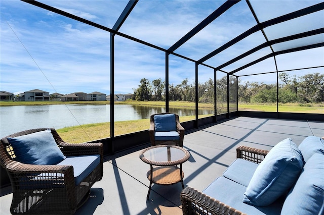 view of patio with a water view and a lanai