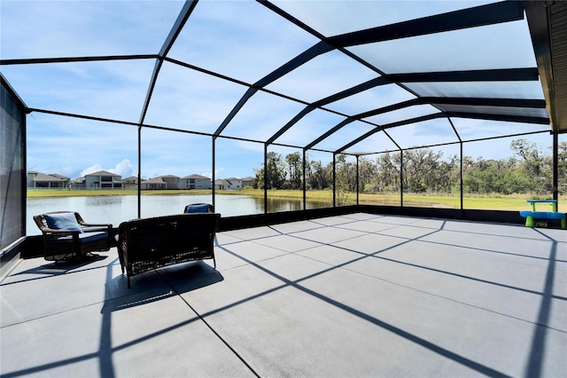 view of patio featuring a water view and a lanai