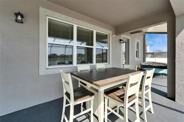 view of patio with outdoor dining area and fence