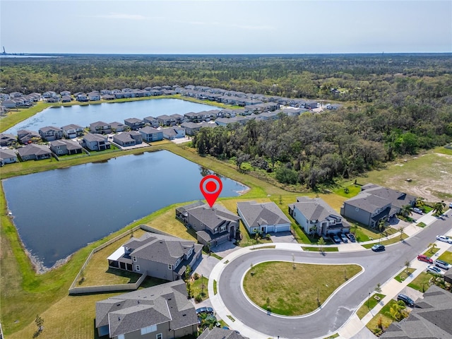 drone / aerial view with a residential view and a water view