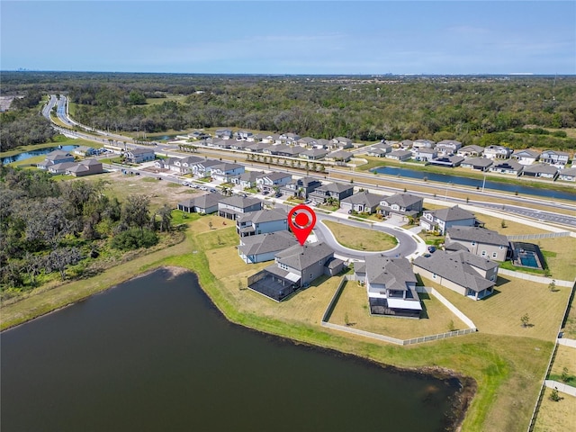 drone / aerial view with a residential view and a water view