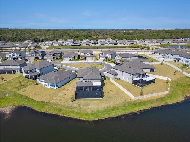 drone / aerial view featuring a residential view and a water view