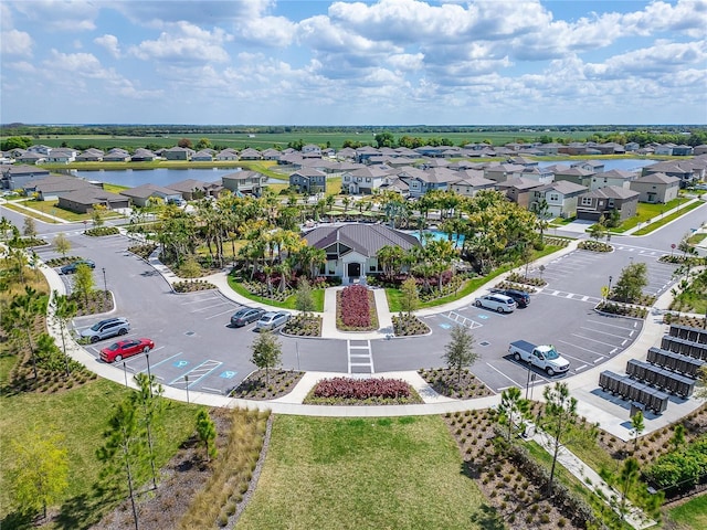 drone / aerial view featuring a residential view and a water view