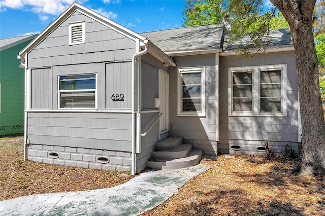 view of front of home featuring crawl space and a shingled roof