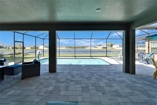 pool featuring glass enclosure and a patio