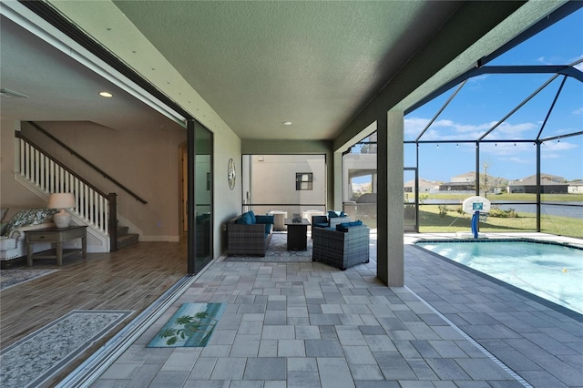 view of patio / terrace featuring a lanai, an outdoor pool, visible vents, and an outdoor hangout area