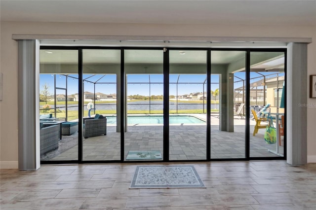 doorway featuring a sunroom and baseboards