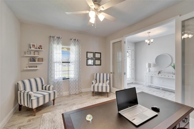 office with light wood finished floors, baseboards, and ceiling fan with notable chandelier