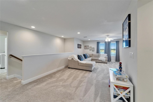 living area with recessed lighting, light colored carpet, and baseboards