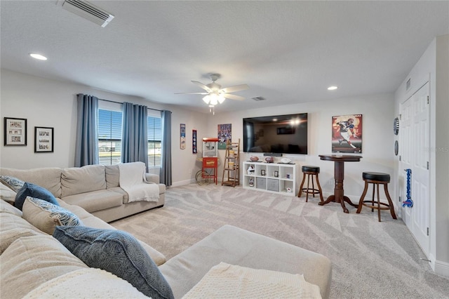 carpeted living room featuring recessed lighting, visible vents, and baseboards