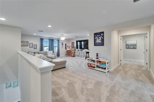 living area with ceiling fan, recessed lighting, light carpet, visible vents, and baseboards