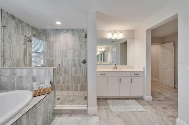 full bath with a garden tub, a shower stall, vanity, and baseboards